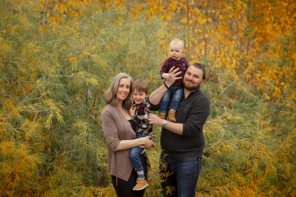 Family photo in front of the mahogany wetlands in the early fall