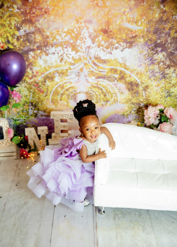 African girl in a beautiful lavender gown and updoo for a birthday photosession