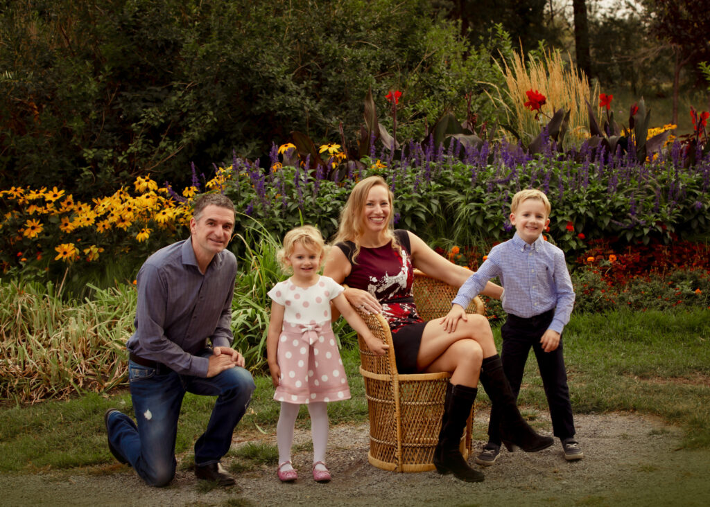 Formal family portraits in Carburn Park surrounded by fresh flowers