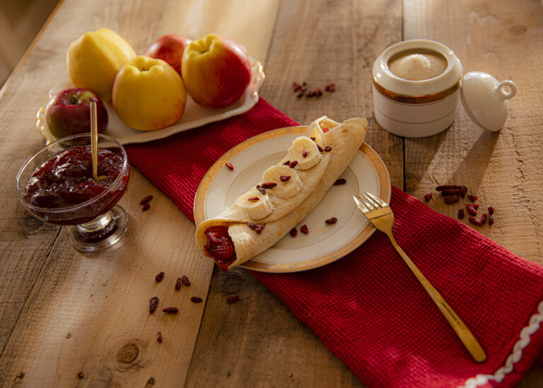 Birds eye view of crepes and Goji berries on a rustic table