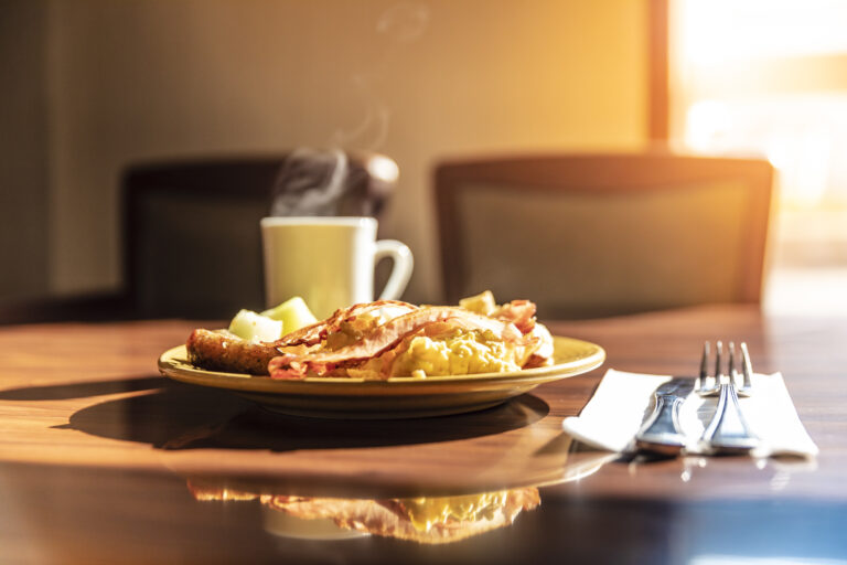 steaming coffee beside savoury dish