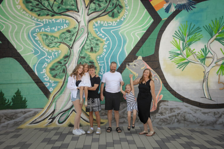 Family photos in front of a graffitti wall in inglewood