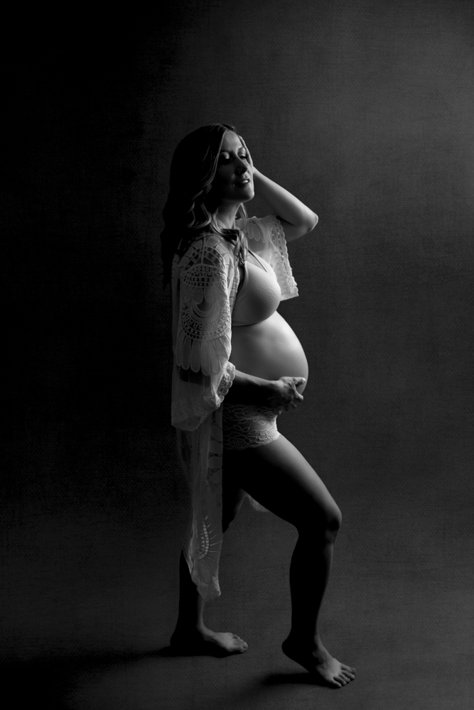 Silhouette pregnancy photo showing off round belly