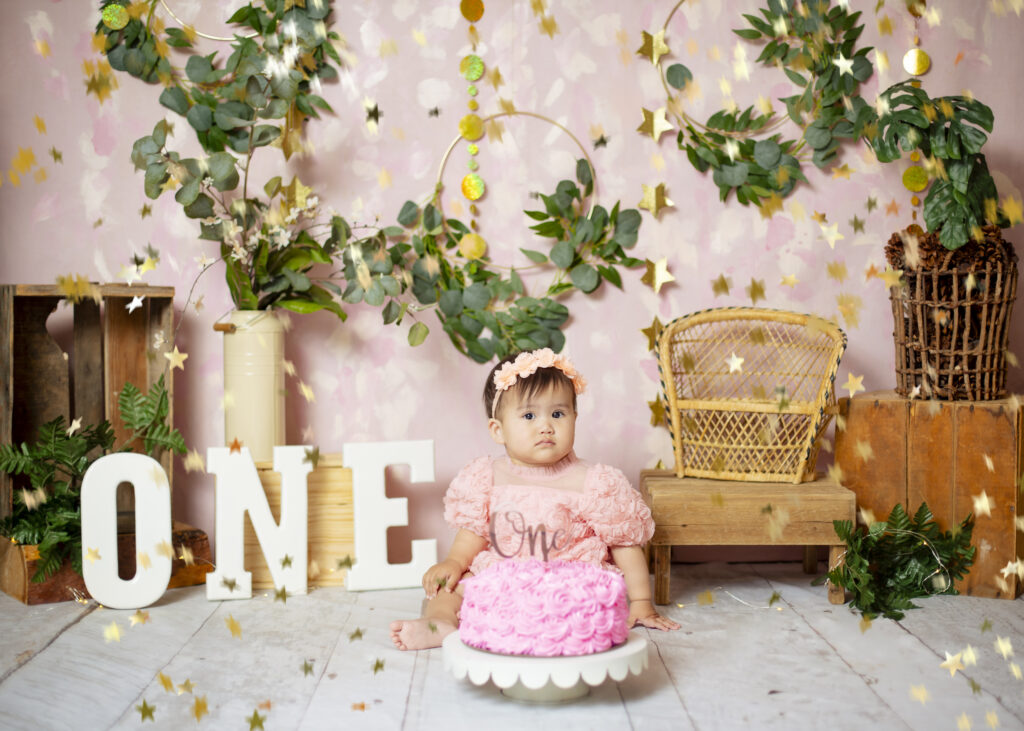 Baby Girl on a pink background with cake
