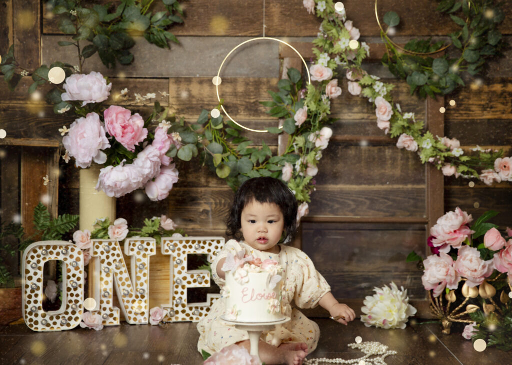 Baby Girl in a birthday cake smash photosession