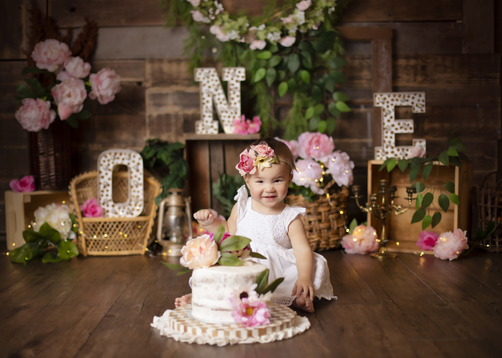 Girl smashing a large birthday cake on birthday photoshoot