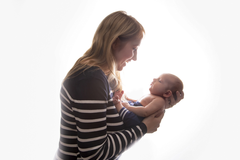 Mom holding older newborn baby
